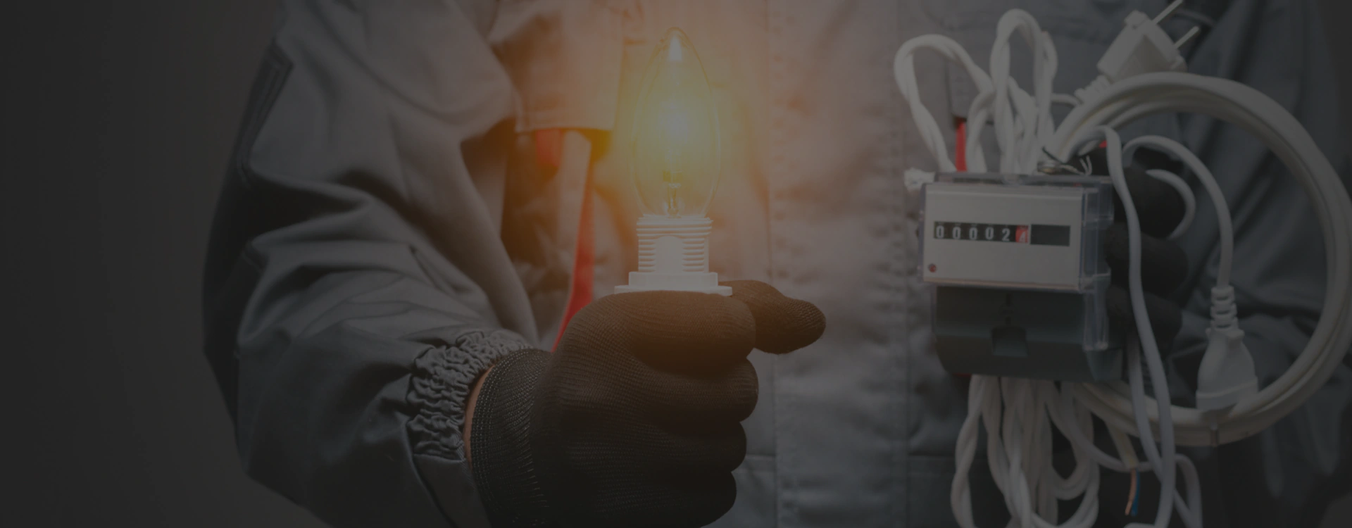 electrician holding bulb and electrical wires