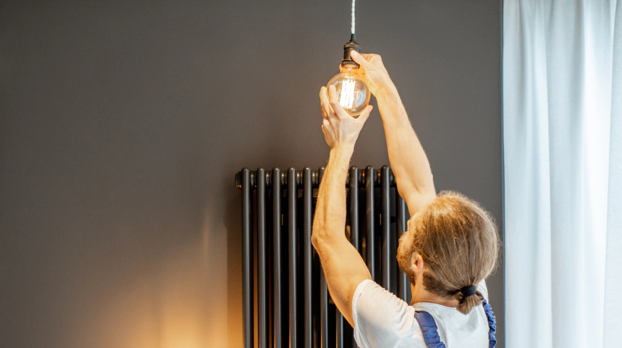 worker doing lighting installation